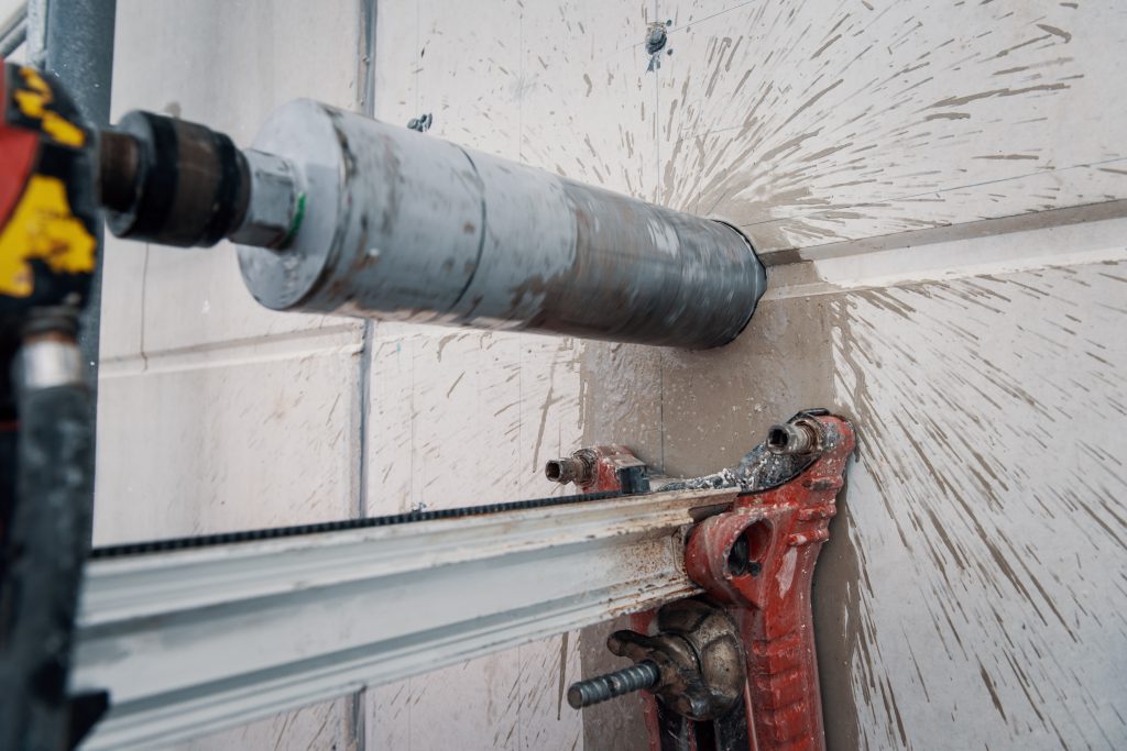 Drilling a hole into a concrete floor with core driller